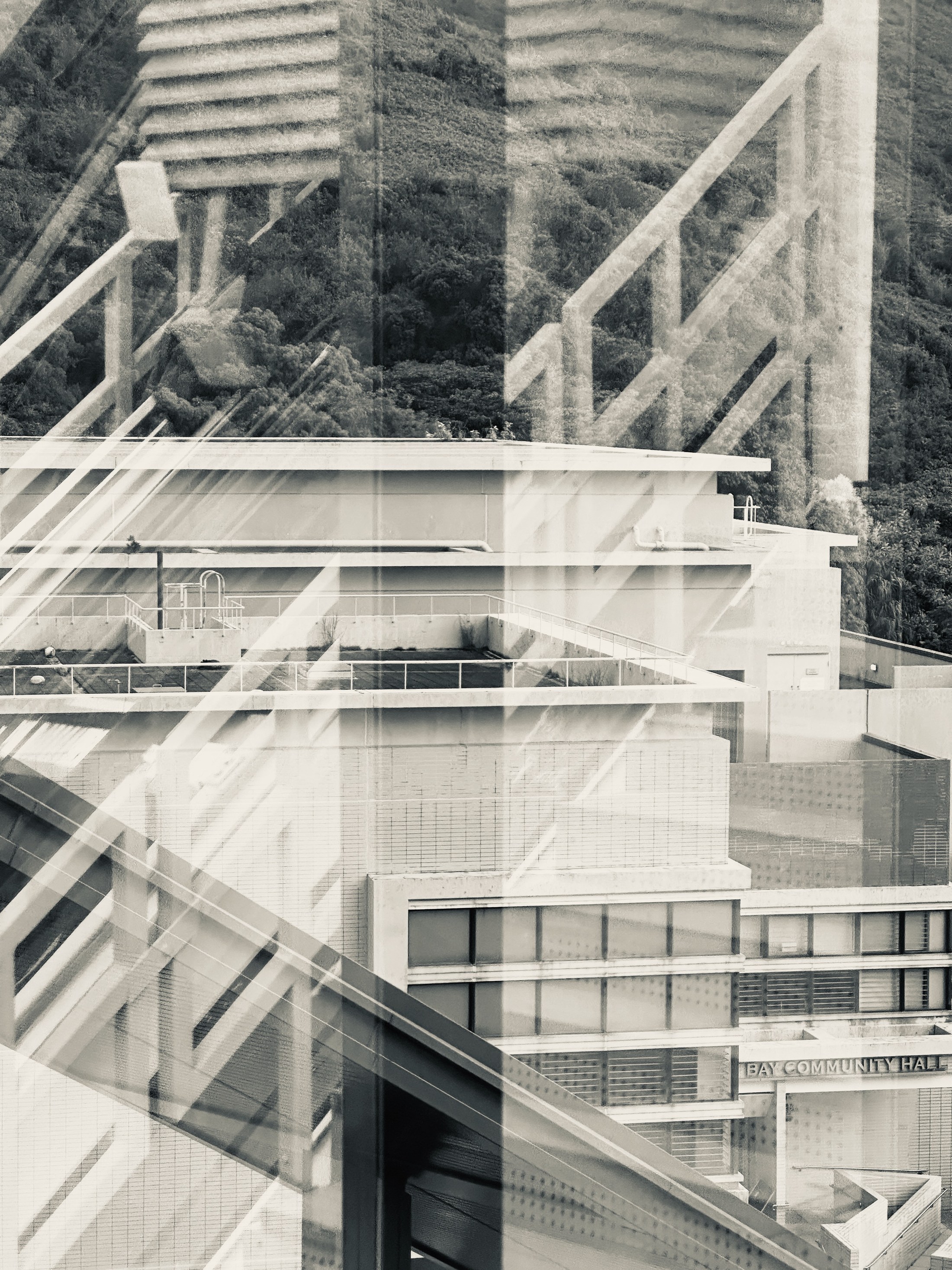 Overlapping stair rails and building façades forming a dense translucent geometric pattern.